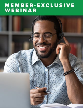 A smiling man wearing headphones participating in a video conference. 